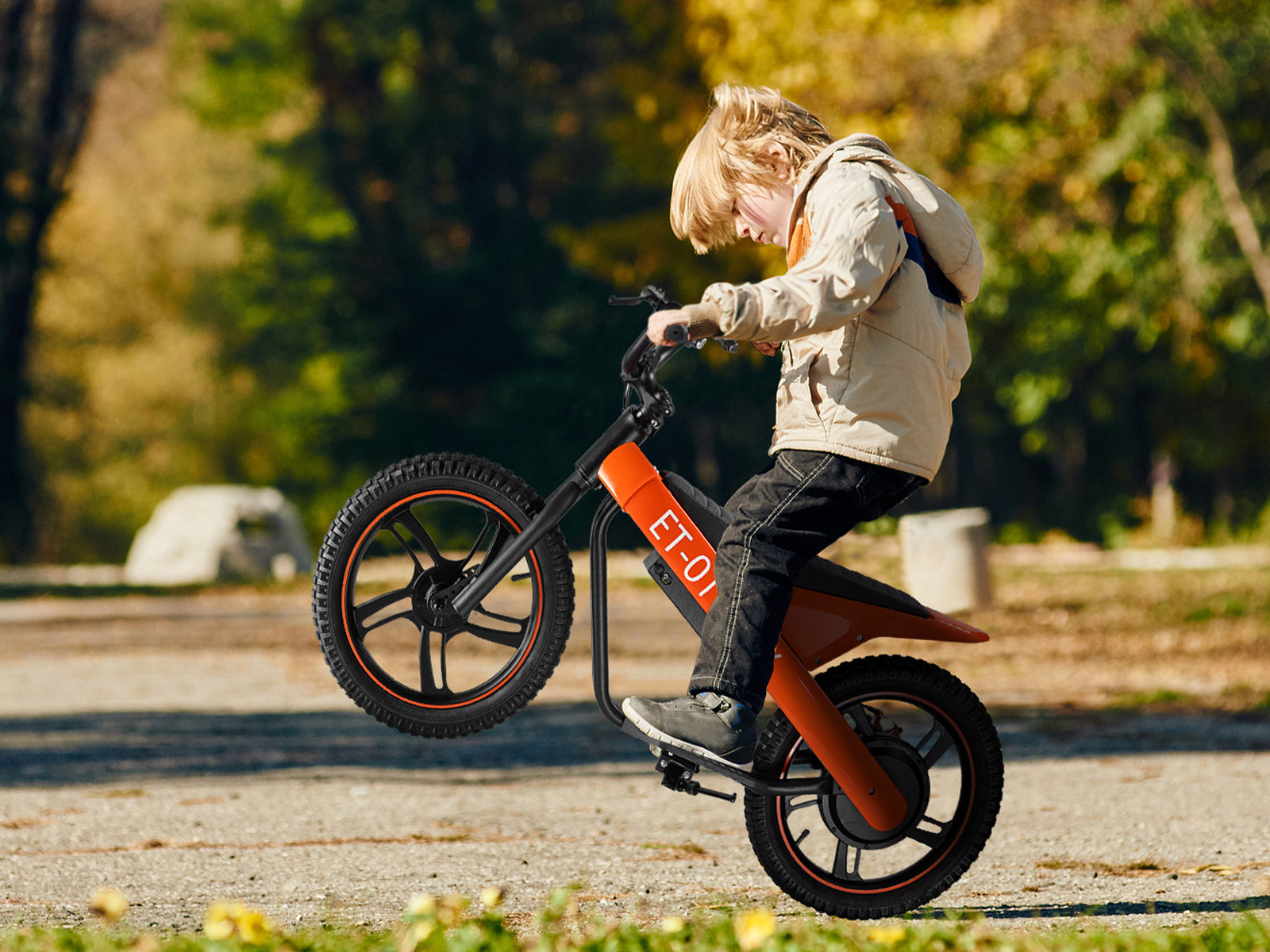 A young rider safely navigating a dirt trail on a DuoDian electric dirt bike, demonstrating proper sizing, bent elbows, and correct riding posture.